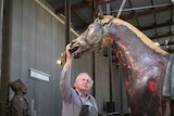 Sculptor Carl Valerius touching his statue of WW1 war horse Bill the Bastard