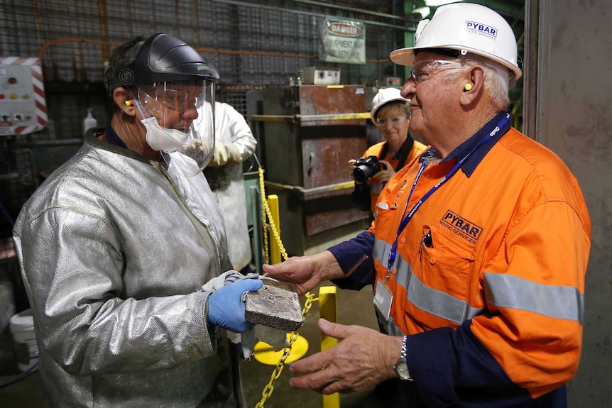 Henty gold mine employee with a gold bar
