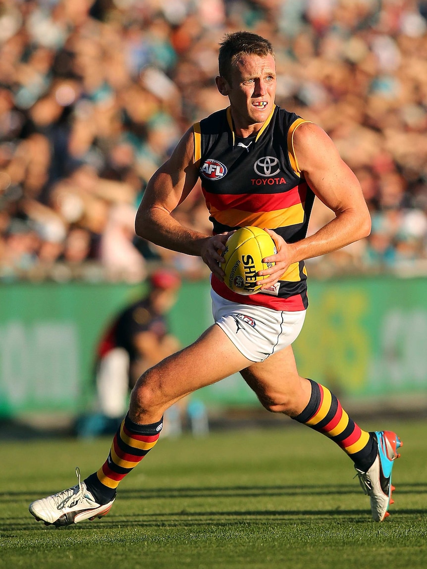 Adelaide's Brent Reilly runs with the ball against Port Adelaide at Football Park in April 2013.
