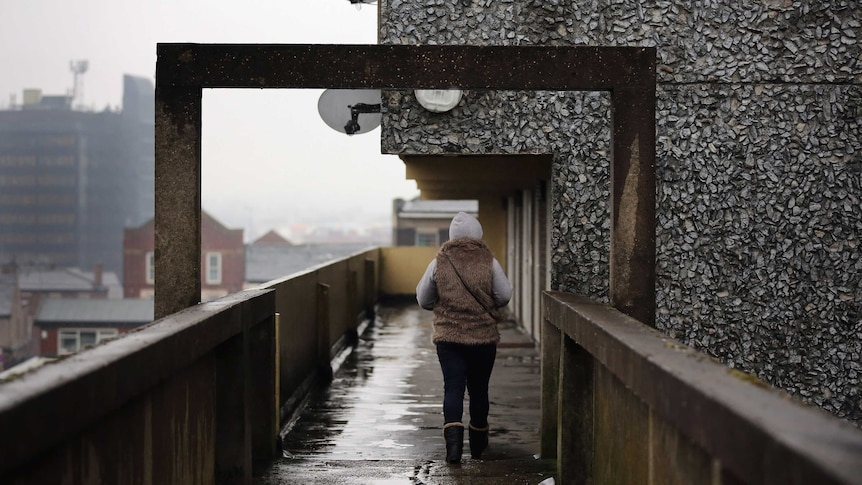 A woman on a walkway in the Falinge Estate, Rochdale, Lancashire.