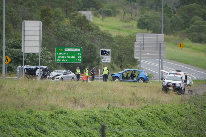 scene of a crash with cars crumpled.