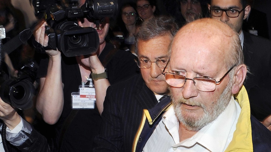 PIP breast implant founder Jean-Claude Mas is surrounded by media