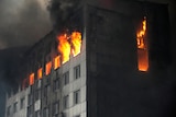 A building is engulfed in flames after shelling in Kyiv