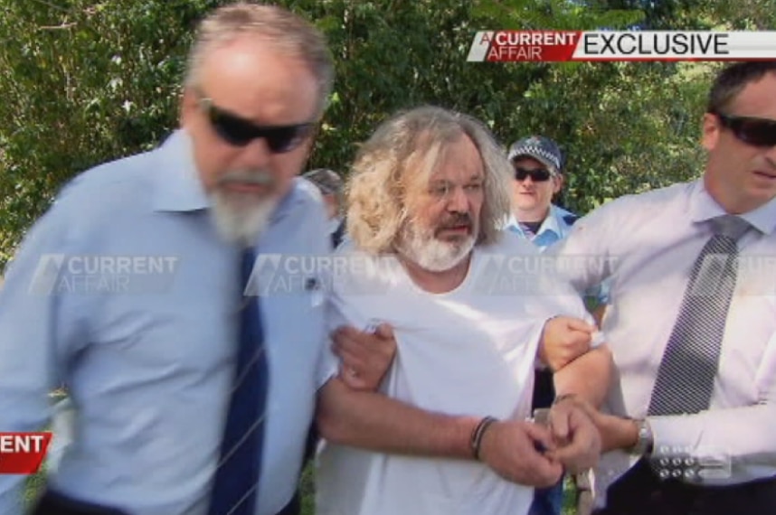 Peter Foster, looking unkempt with a long hair and beard is arrested near Byron Bay in northern New South Wales in 2014.