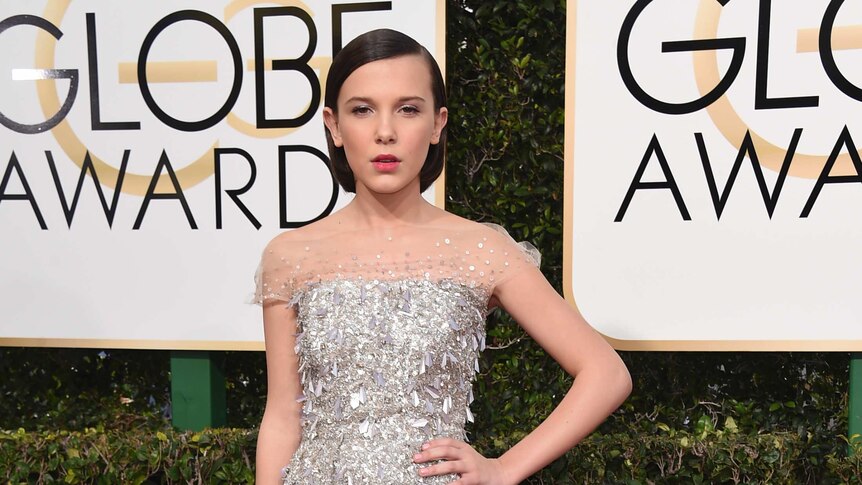 Millie Bobby Brown, actress of Stranger Things, arrives at the 74th annual Golden Globe Awards wearing a silver shiny dress