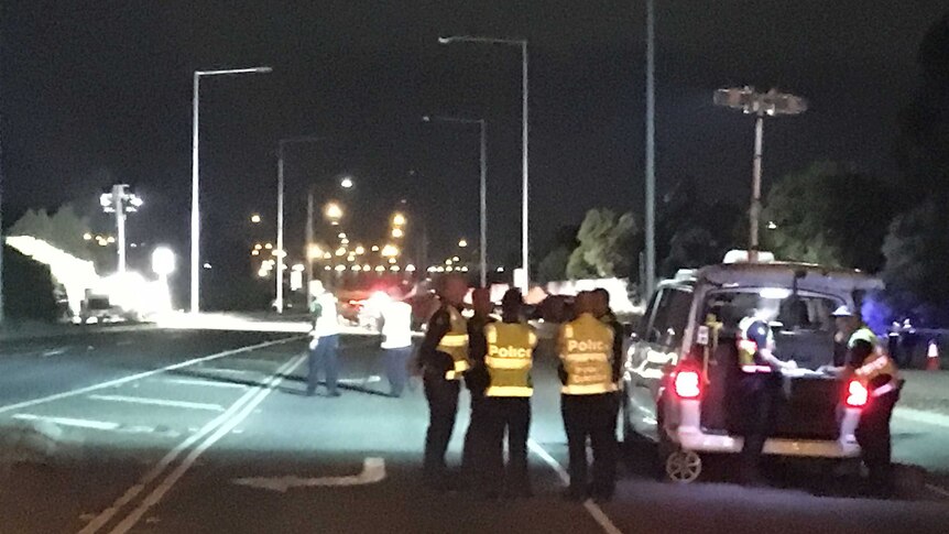 Police officers at the scene of the crash at Point Cook.