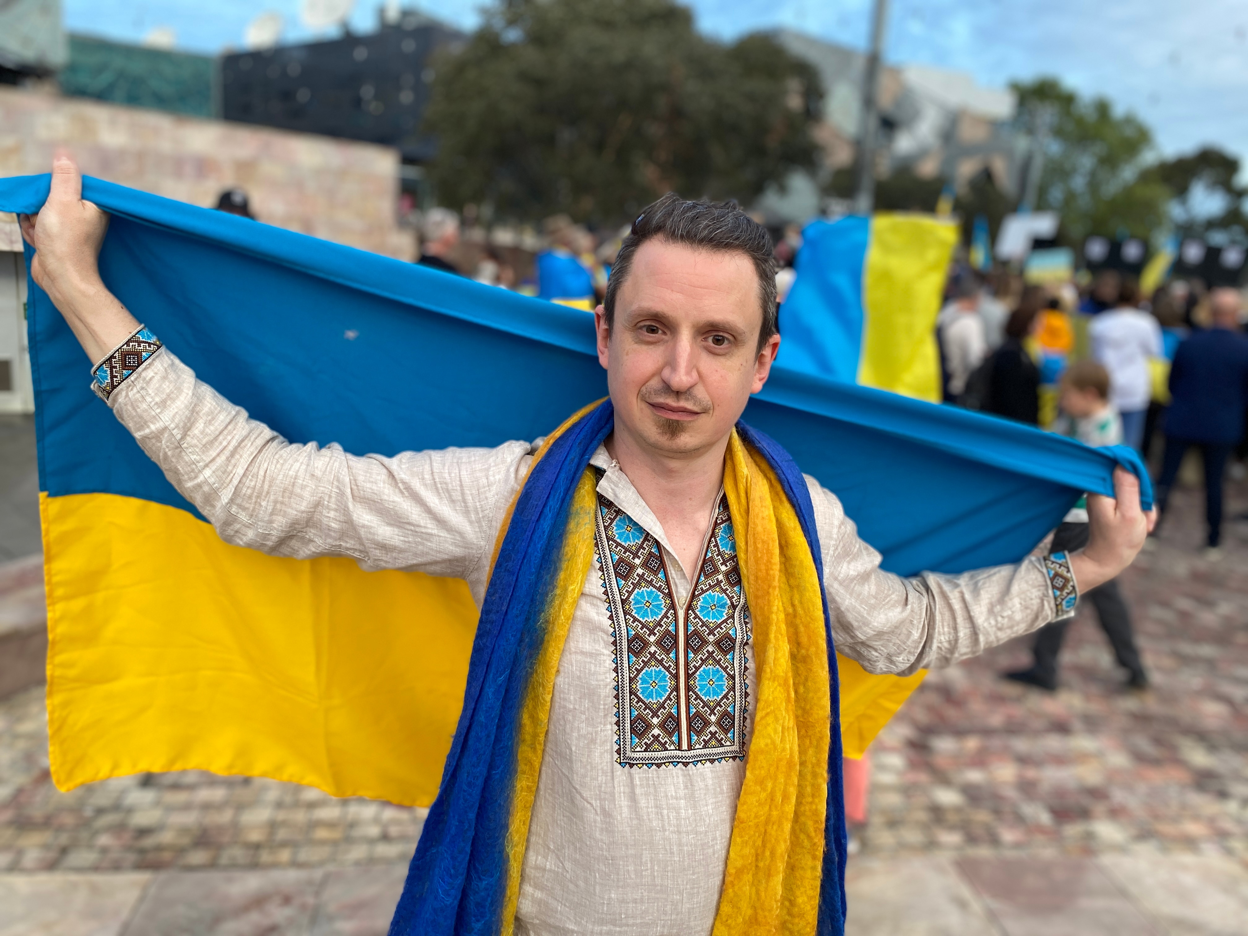 A man holding a Ukrainian flag.