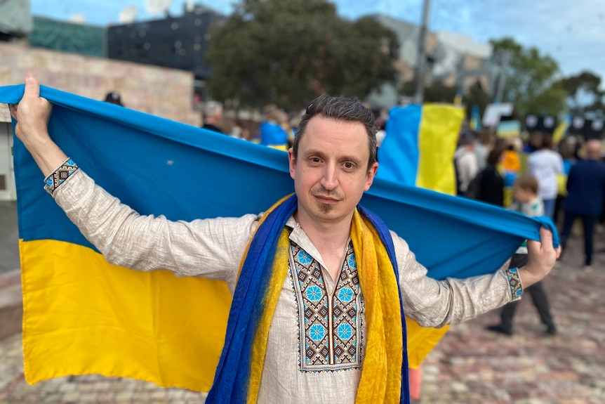 A man holding a Ukrainian flag.