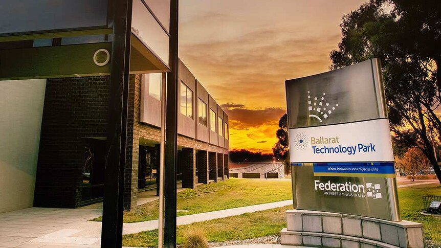 A Federation University sign at sunset