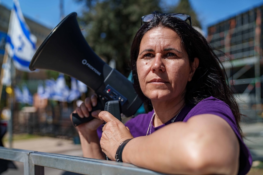 A woman holding a megaphone.