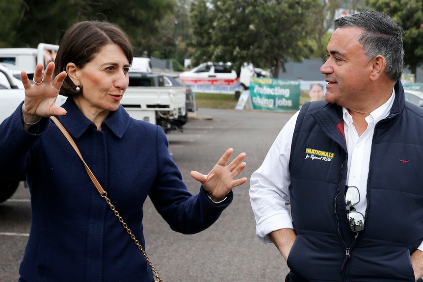 A woman and a man walking and speaking