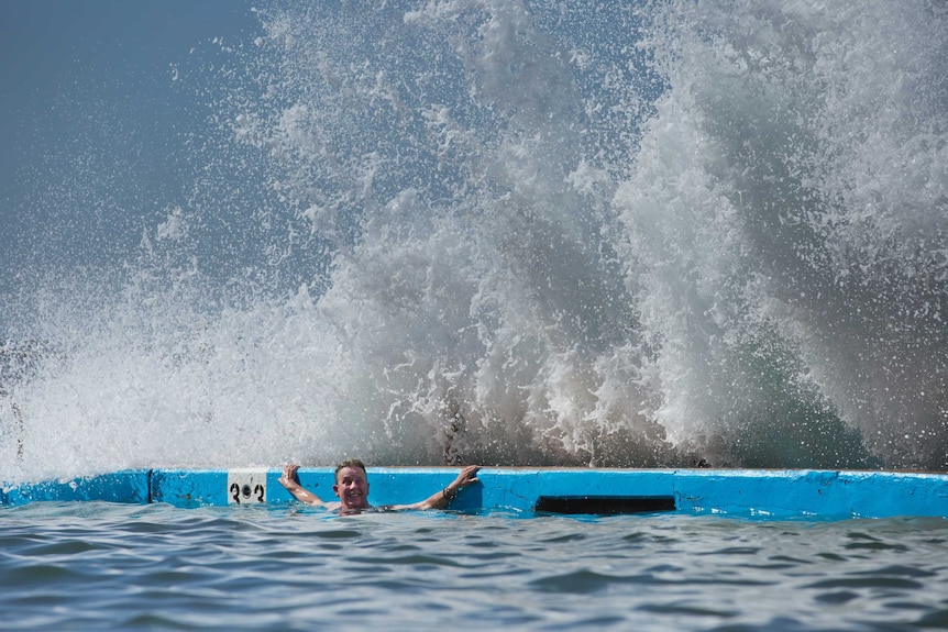 A wave crashes over Beth McDougall in an ocean pool.