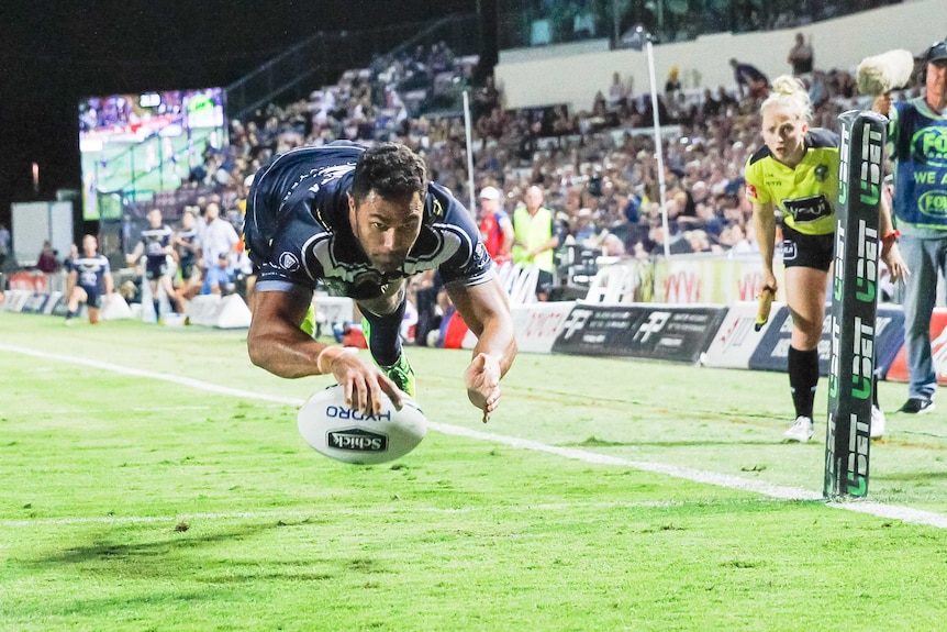 Justin O'Neill of the Cowboys scores a try against the Knights in Townsville on July 27, 2018.