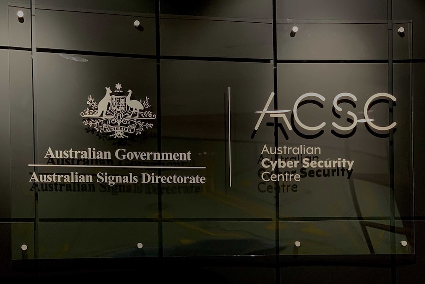 A sign against a grey wall stating the Australian Cyber Security Centre and the Australian Signals Directorate.