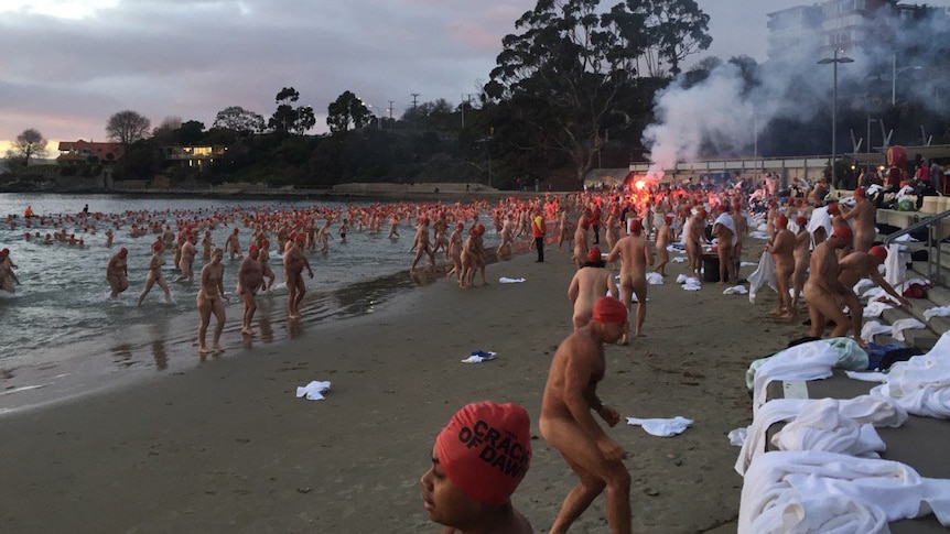 Swimmers exit the water after Dark Mofo's 2017 winter solstice nude swim.