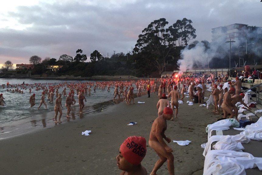 Swimmers exit the water after Dark Mofo's 2017 winter solstice nude swim.