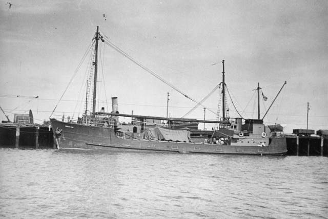 Black and white photo of a ship at a wharf