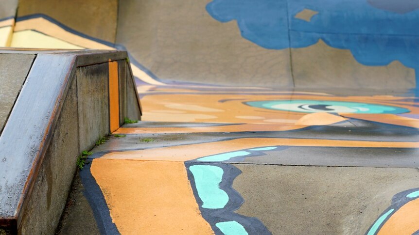 A close-up shot of a squid's arm in a mural painted on a skatepark.