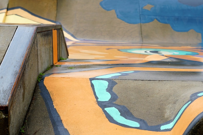 A close-up shot of a squid's arm in a mural painted on a skatepark.