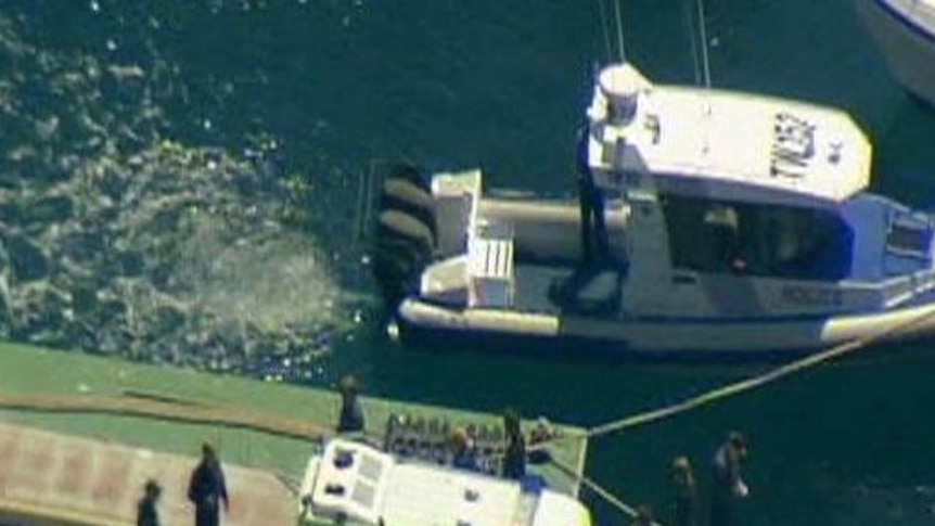 Woman is transported into an ambulance after suffering a shark attack