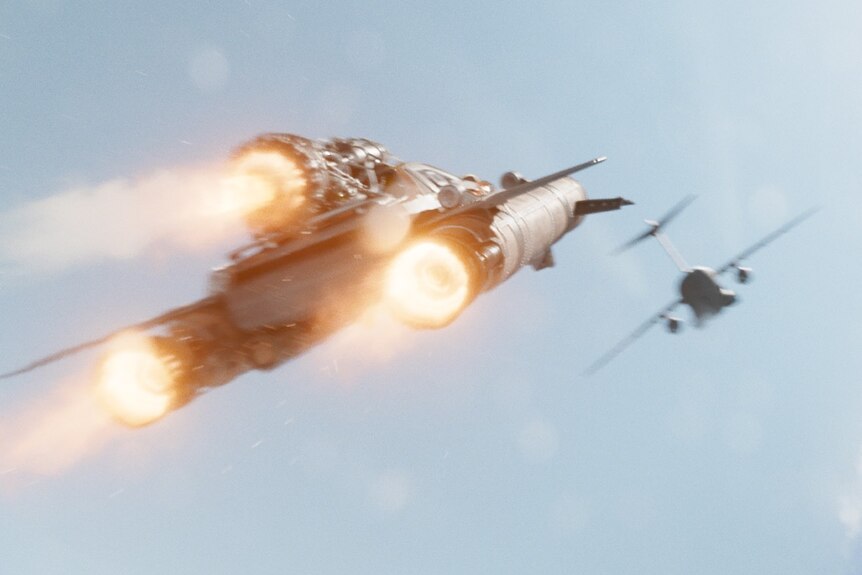 A spaceship styled like a car chases a plane in Fast and Furious 9