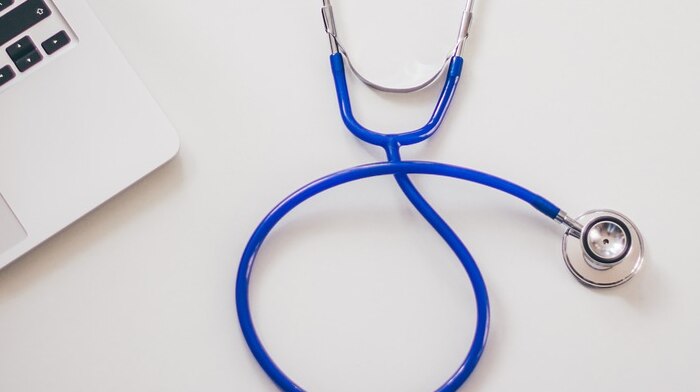 Image of a stethoscope, and laptop