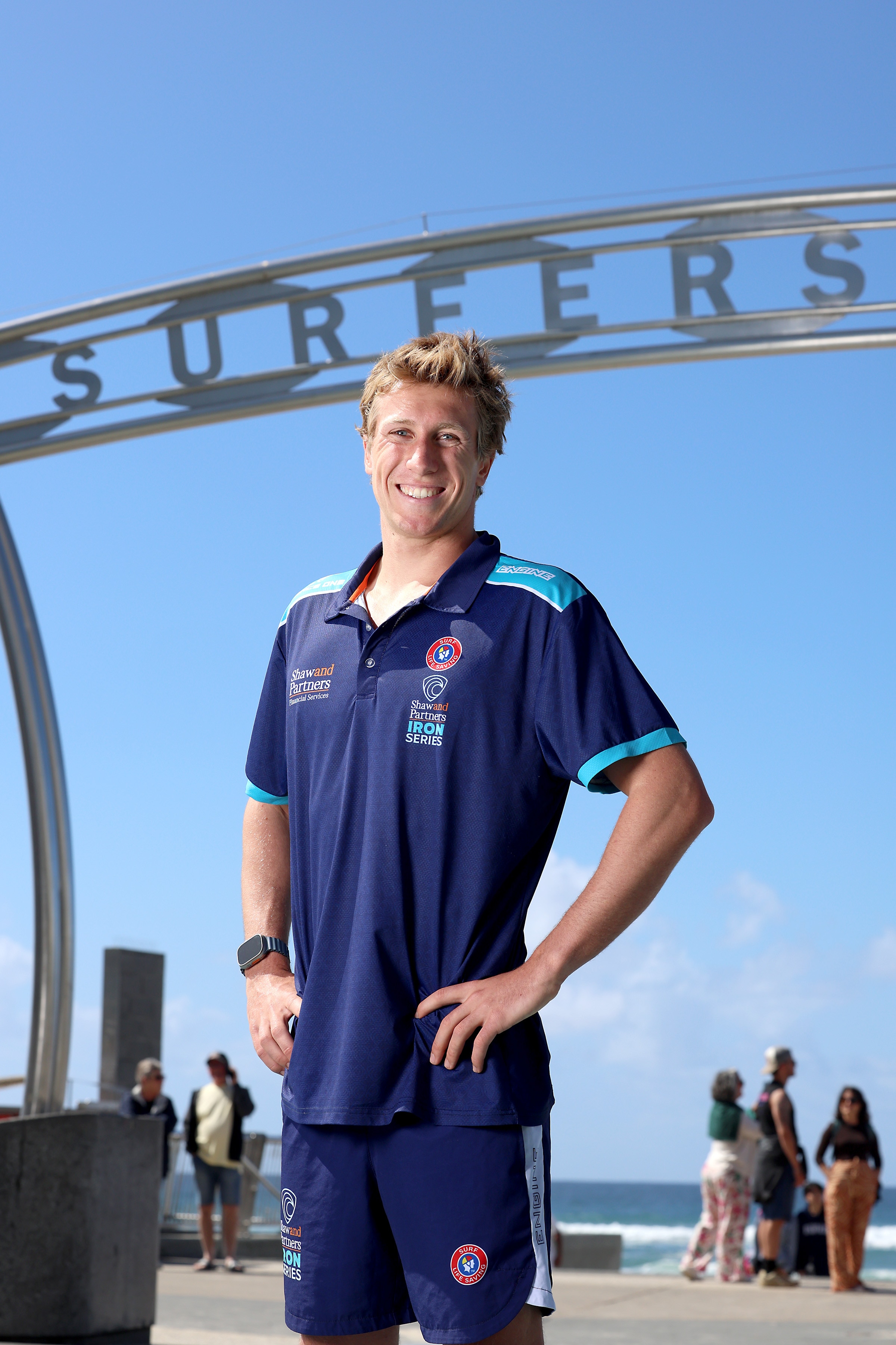Charlie Verco smiles under the Surfers Paradise sign