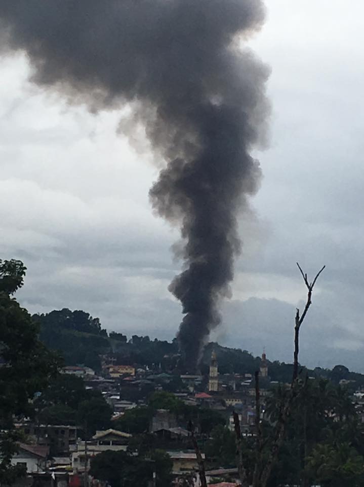 Black smoke is seen rising above Marawi City.