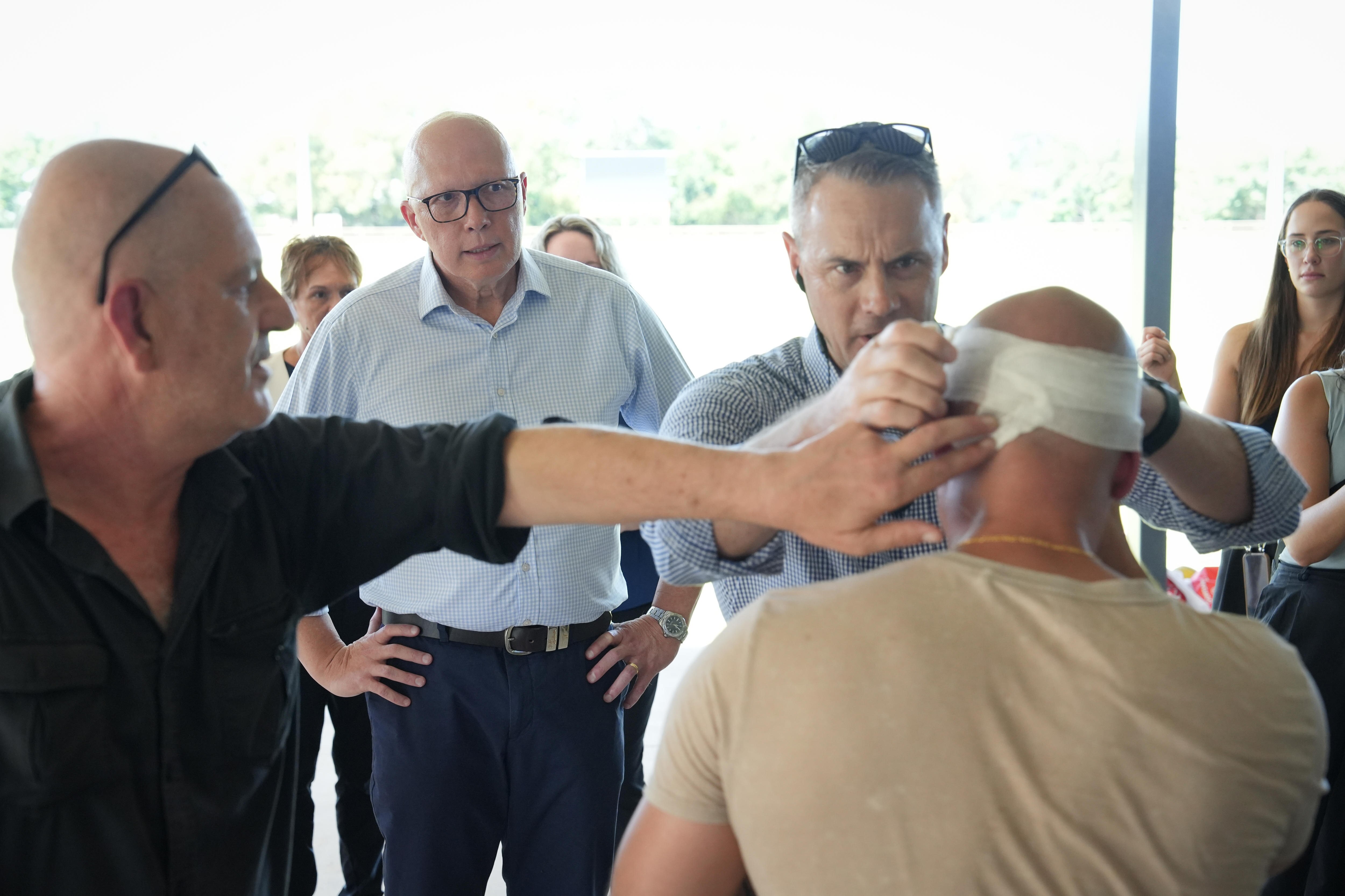 Dutton watches as camera operator gets his head bandaged