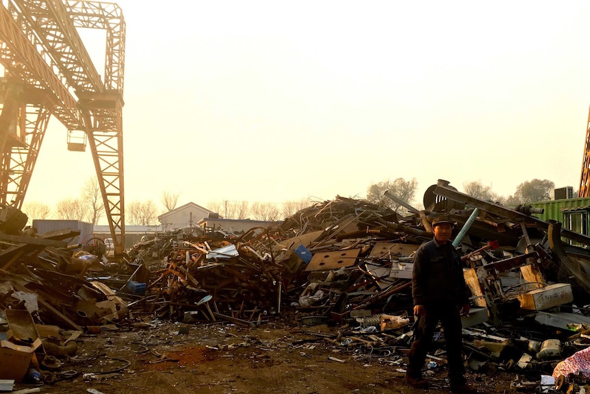 A worker at a scrap metal recycling facility at Tongzhou, Beijing.