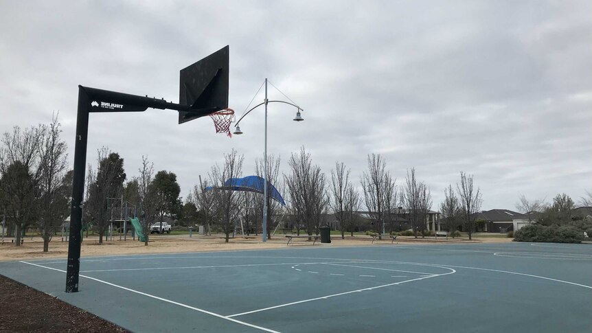 A basketball court lies empty in a park at Taylor's Hill.