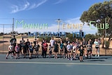 A group of young people standing in front of a sign that says Mannum Tennis Club.