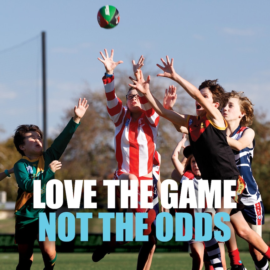 The words Love the Game Not the Odds over an image of children playing Australian rules football.