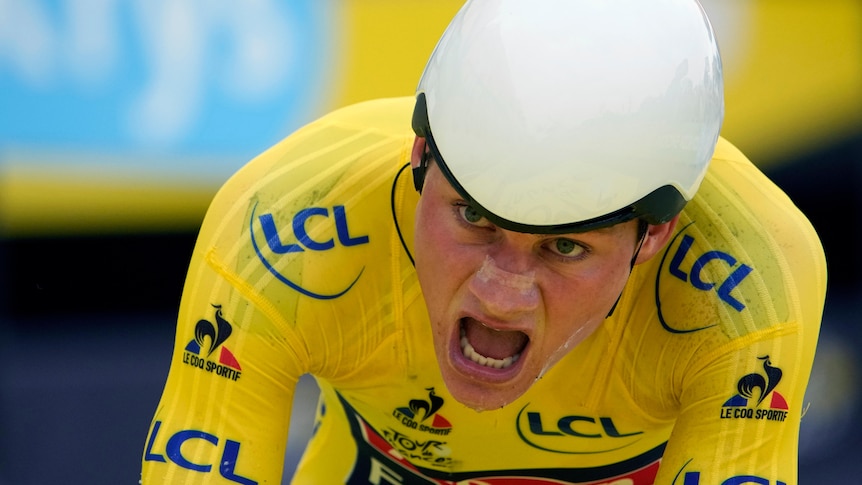 A cyclist in a bright competition jersey gasps for air as he rides.