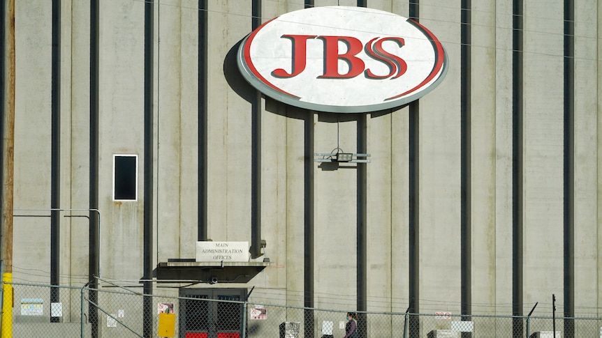 A warehouse with the logo of JBS on it. 
