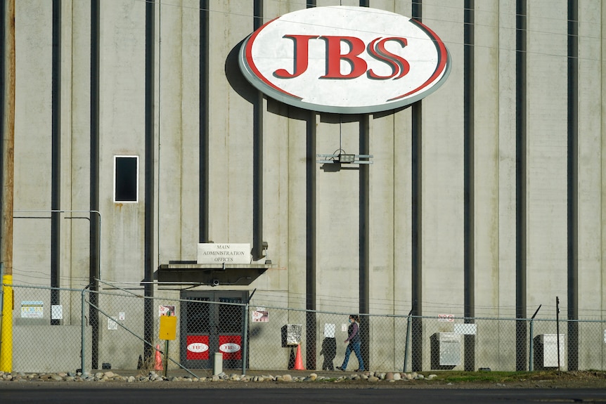 A warehouse with the logo of JBS on it. 