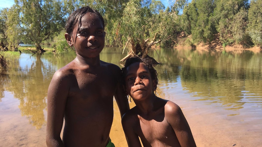 Two Aboriginal children play in McArthur River near Borroloola.