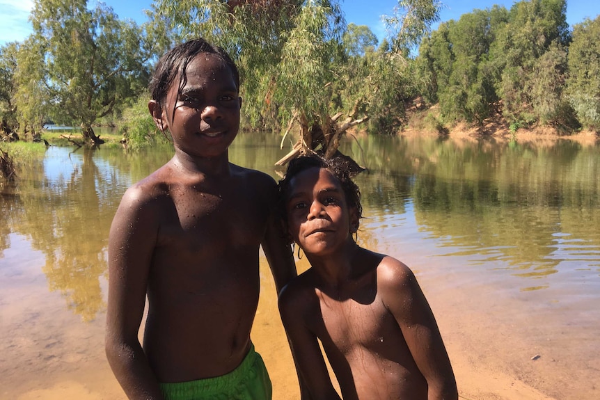 Two Aboriginal children play in McArthur River near Borroloola.