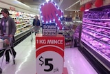 Shoppers in a Coles supermarket aisle.