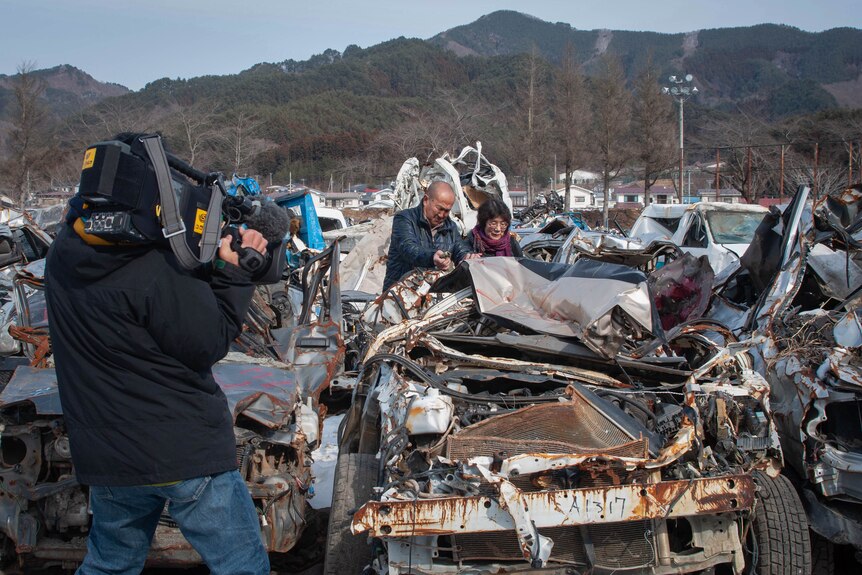 ABC cameraman films people in Japan looking at debris after the 2011 tsunami