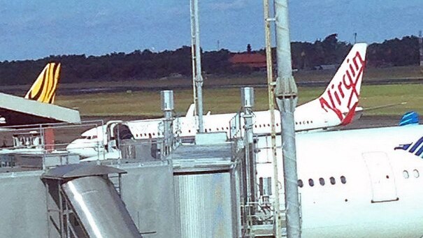 A Virgin Australia plane sits at Denpasar airport in Bali after it was forced to land due to an unruly passenger.