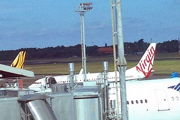 A Virgin Australia plane sits at Denpasar airport in Bali after it was forced to land due to an unruly passenger.