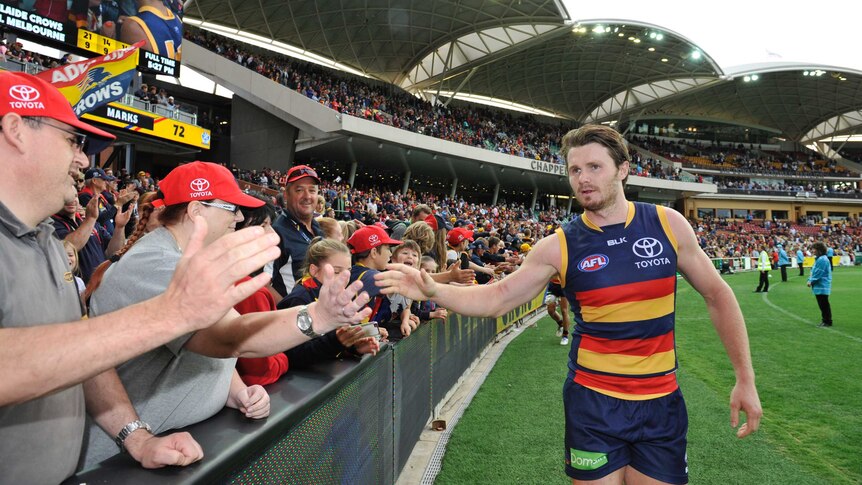 Patrick Dangerfield celebrates a win with Crows fans