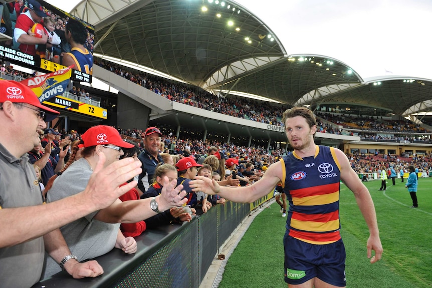 Adelaide's Patrick Dangerfield celebrates with fans after Crows' win over Kangaroos in April 2015.