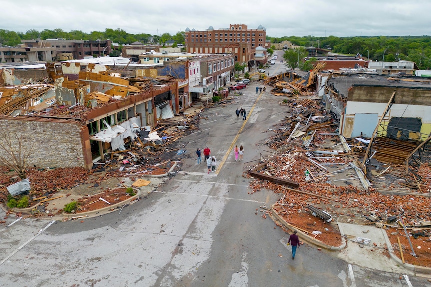An aerial image shows a town main street filled with buildings destroyed by a tornado