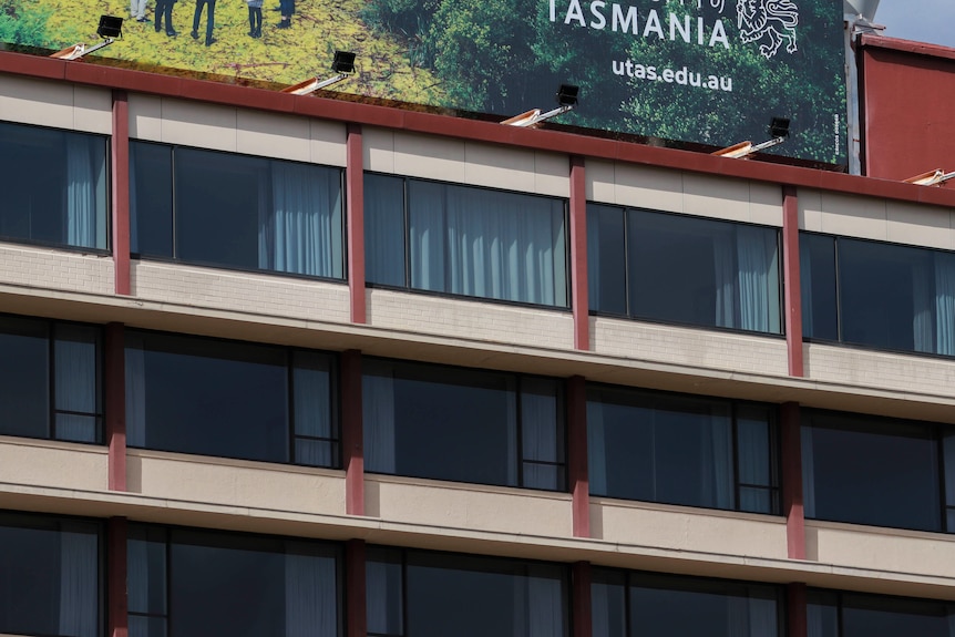 The windows of rooms at the Fountainside accomodation with one room with closed curtains.