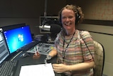 Mandy in radio studio with prosthetic arms.