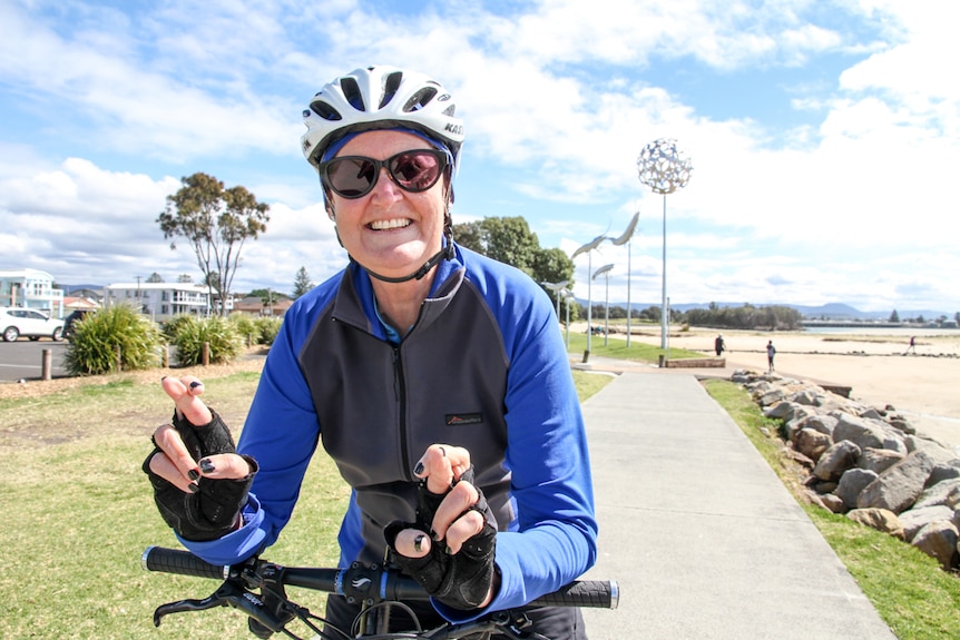 Anne has her fingers crossed as she sits on her bicycle. 