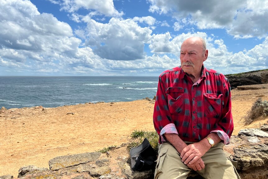 Gerry Billings sits on a stone wall at Thunder Point.