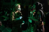 An ADF medic attends to an Afghan evacuee at Kabul's main airport on August 18, 2021.